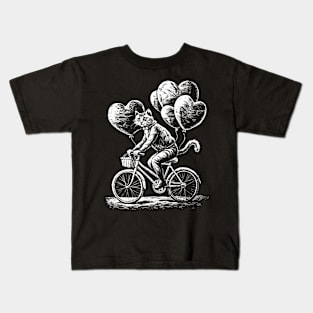 A cat on a bicycle with balloons in the form of hearts Kids T-Shirt